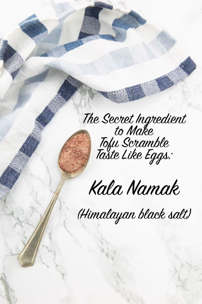 a spoon with Kala Namak on a marble counter top with the writing "the secret ingredient to make tofu scramble taste like eggs: Kala Namak (Himalayan black salt)