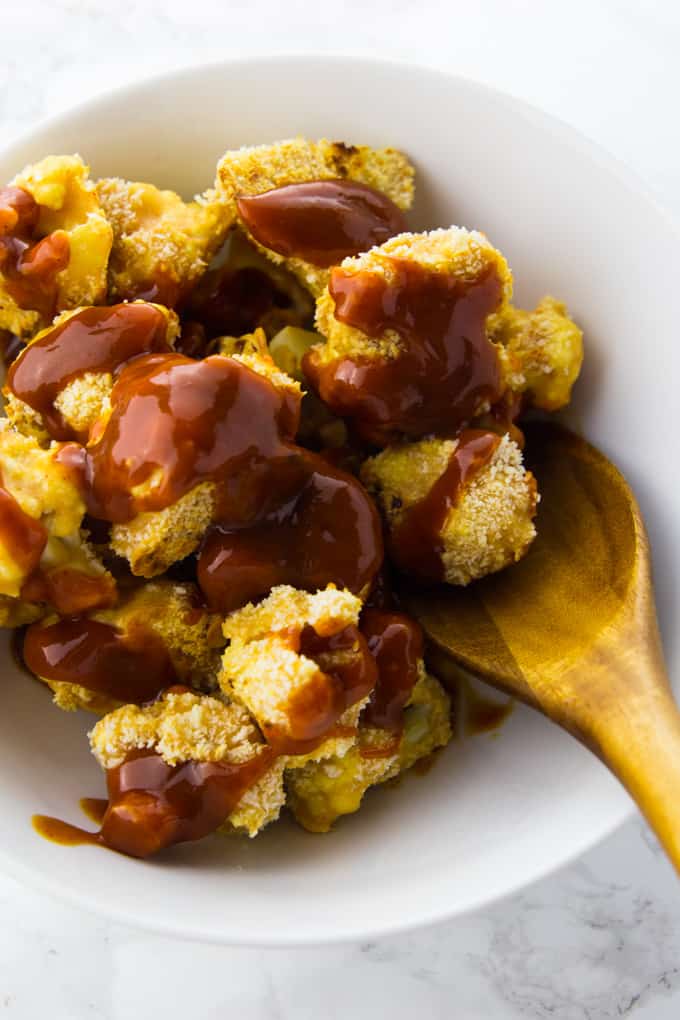 Cauliflower Hot Wings in a bowl with BBQ sauce on top