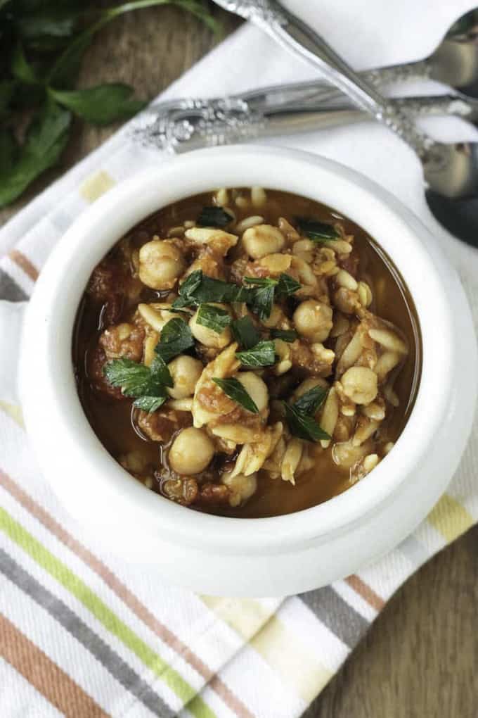 slow cooker red lentil soup in a white bowl on top of a striped dish cloth