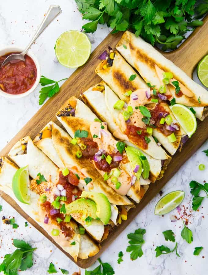 Vegan taquitos on a wooden board