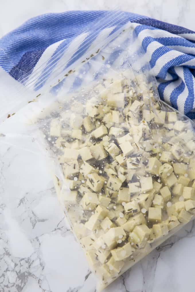 Preparation of vegan feta cheese (marinated firm tofu in a ziploc bag)