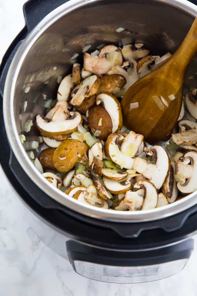 onions and mushrooms are being sautéd in an instant pot