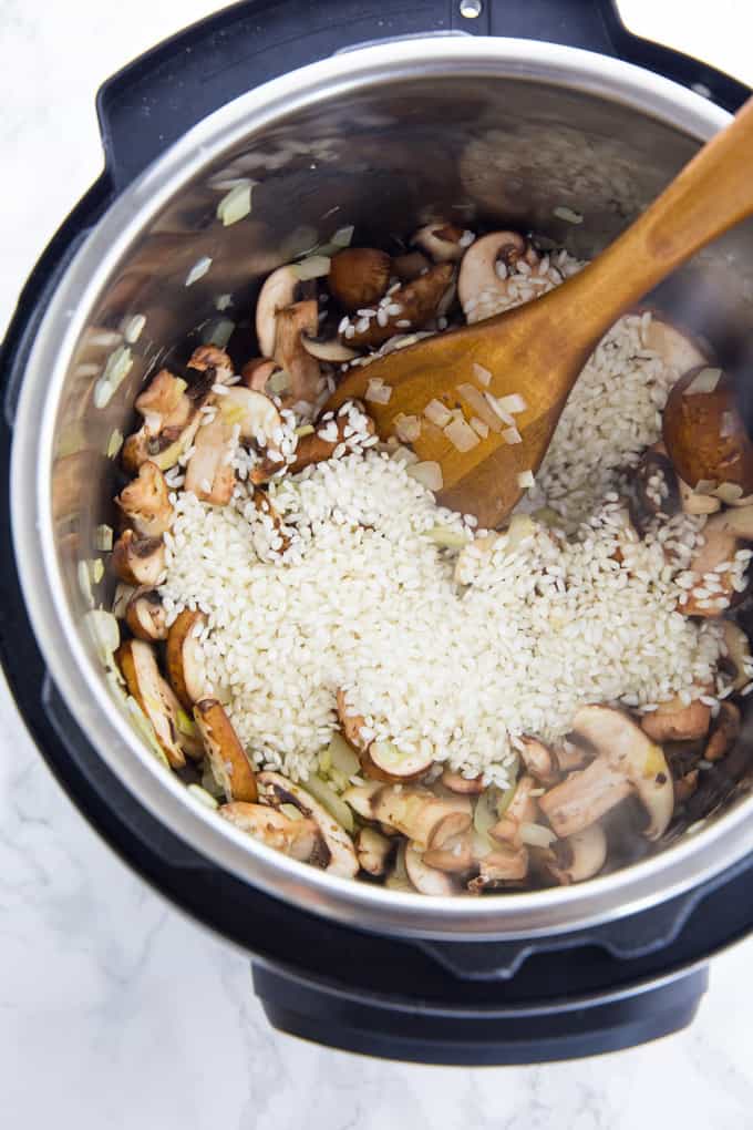 mushrooms, onions, and rice in an instant pot
