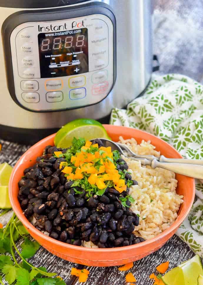 Vegan Seasoned Black Beans in a Bowl with Instant Pot in the Back