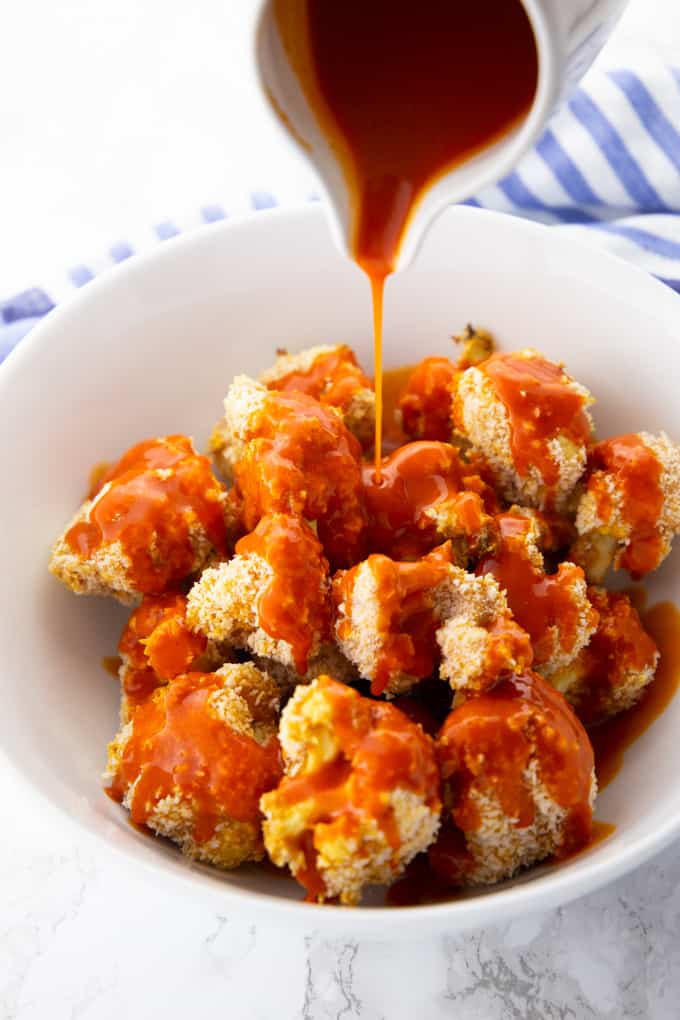 Frank's Red Hot Sauce is Being Poured Over Baked Cauliflower Wings 