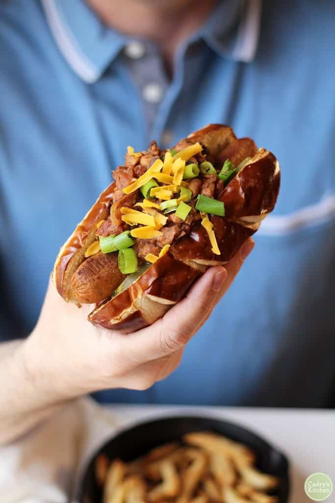 Vegan Chili Dog Being Held in a Hand