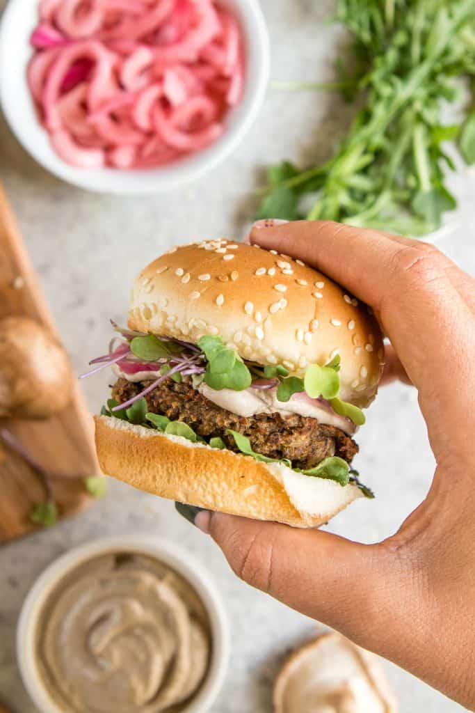 A Hand Holding a Mushroom Veggie Burger