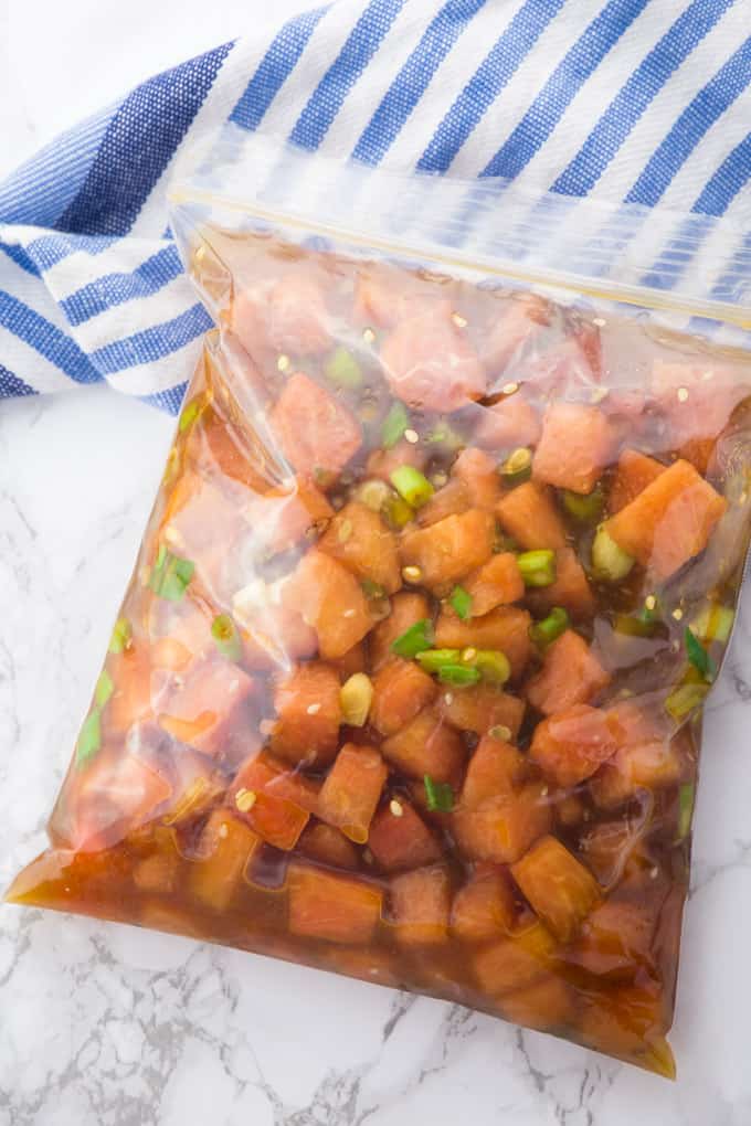 marinated watermelon cubes in a ziploc bag on a marble counter top 