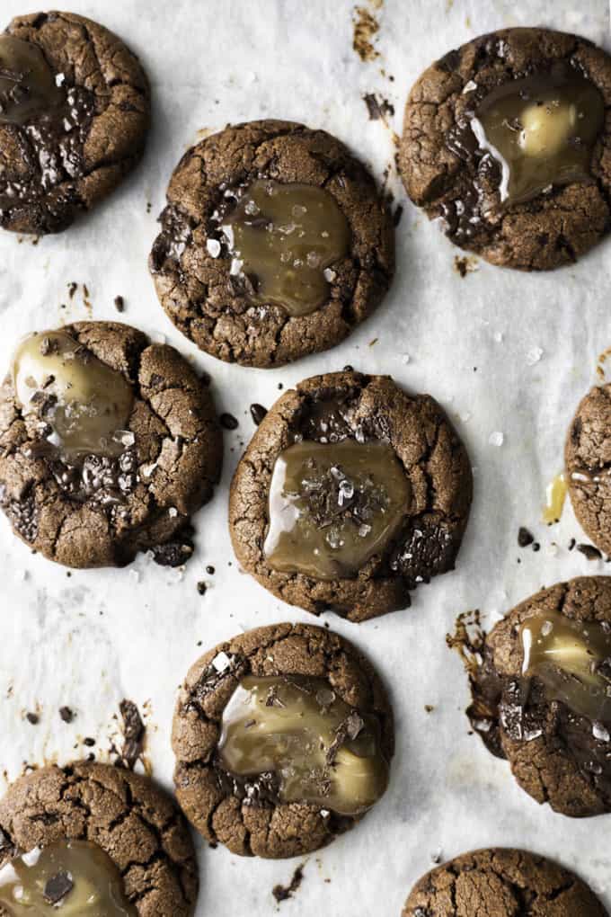 Vegan Chocolate Chip Salted Caramel Cookies on a baking tray lined with parchment paper