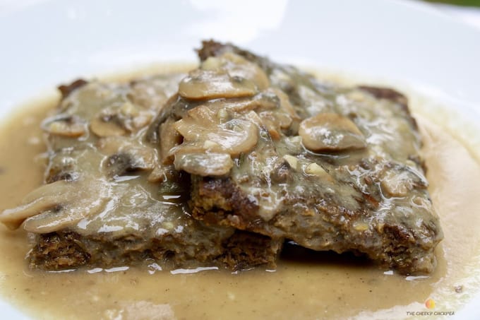 two vegan Salsbury steak with vegan gravy on a white plate 