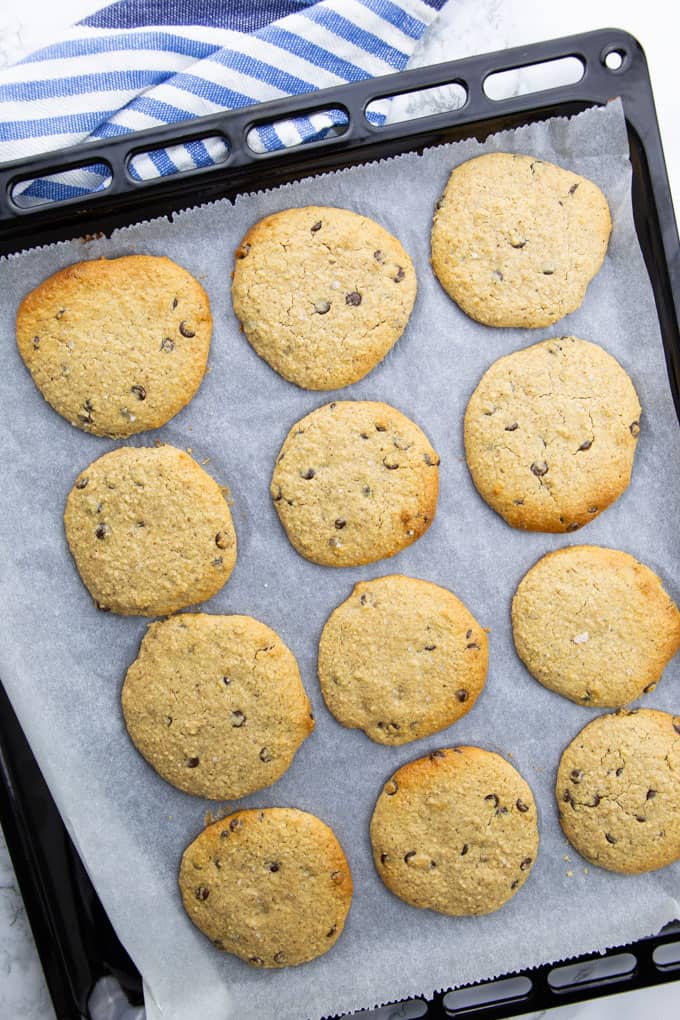 Vegan Peanut Butter Cookies on a baking tray lined with parchment paper after baking 