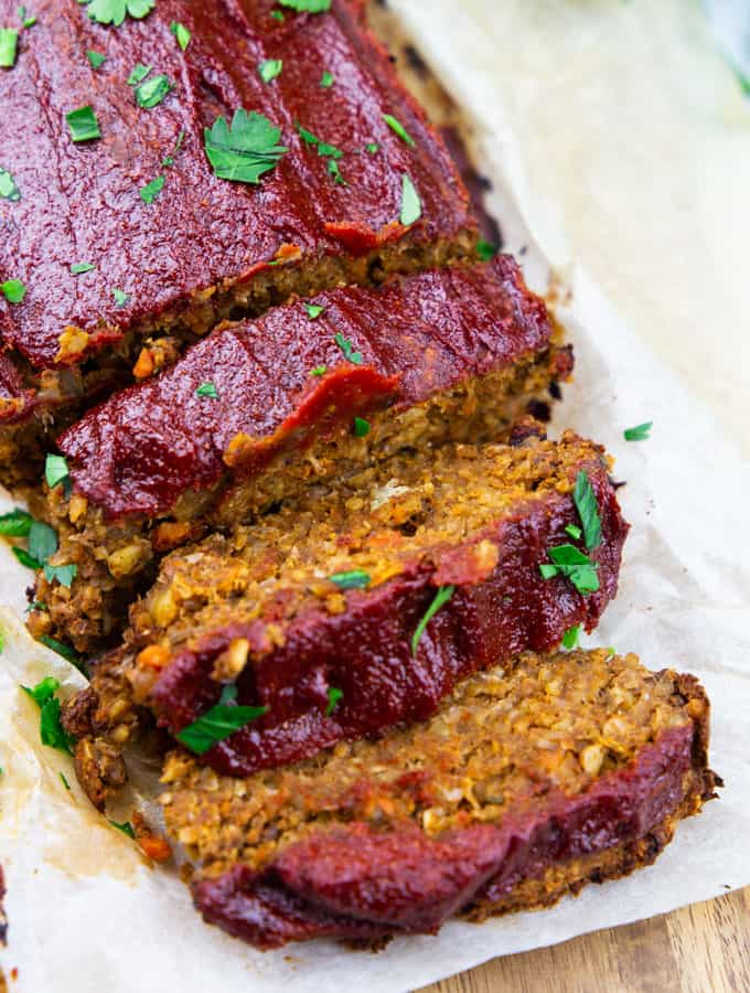 a vegan meatloaf cut into slices on a wooden board