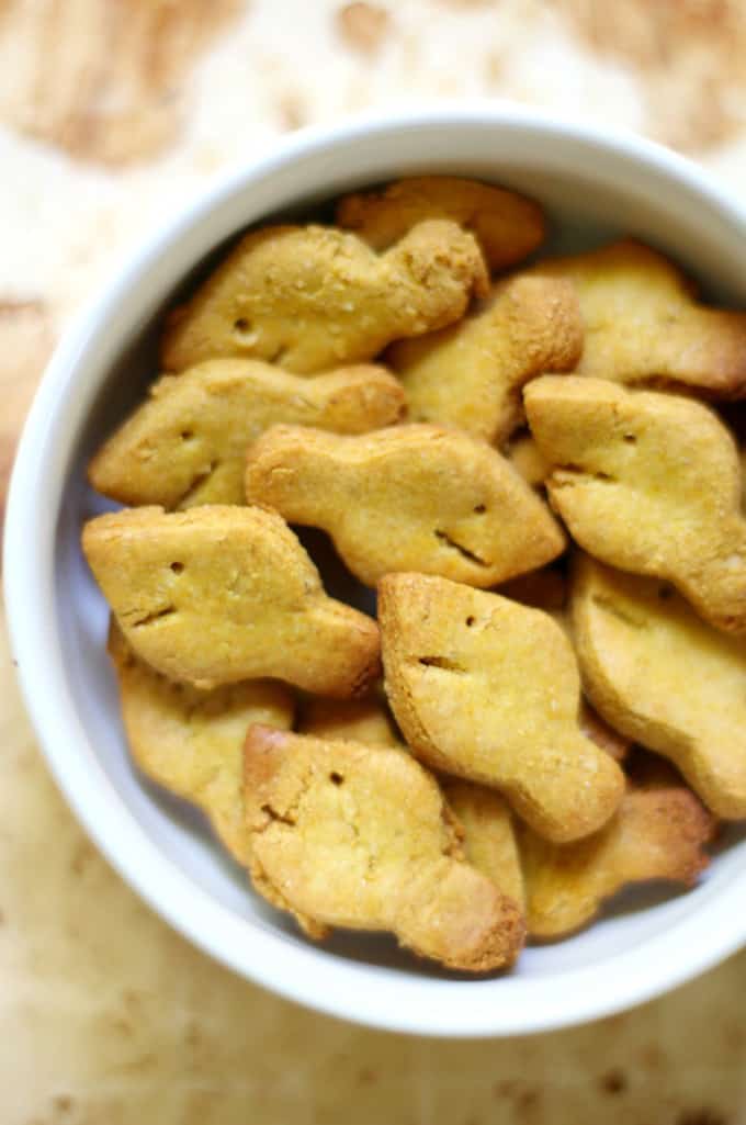 a bowl of vegan goldfish on a wooden countertop 