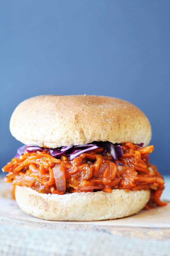 a sandwich with Pulled BBQ Carrots with a blue background