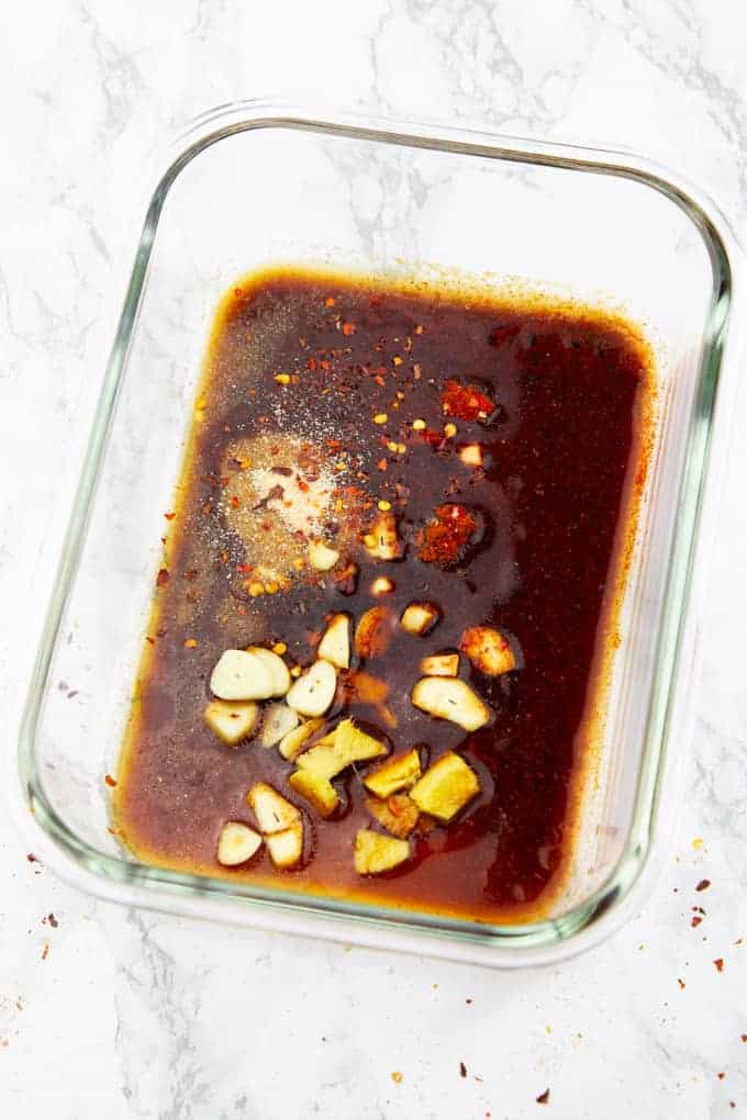 tofu marinade in a square glass bowl on a marble countertop 