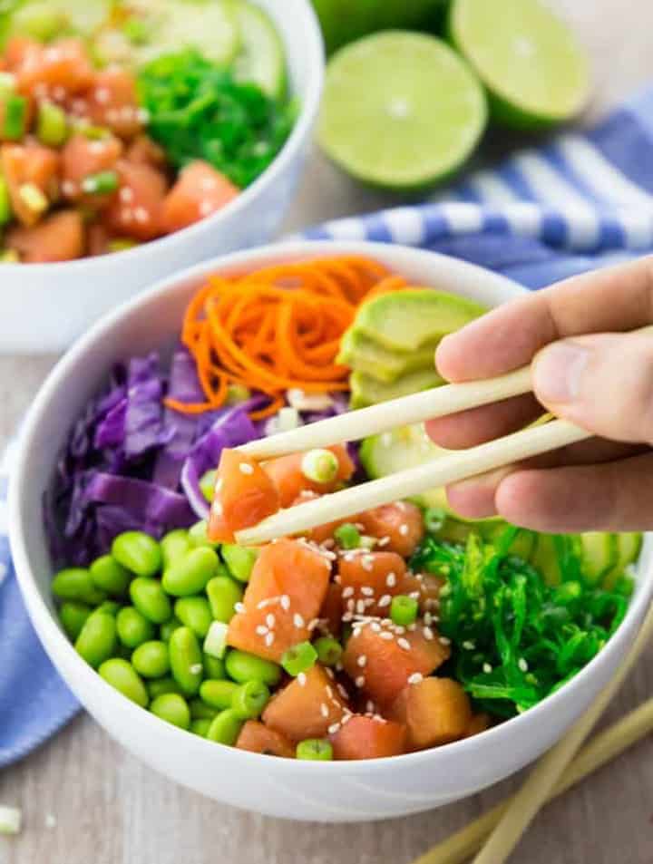 Vegan Poke Bowl with Watermelon with a hand holding chop sticks 