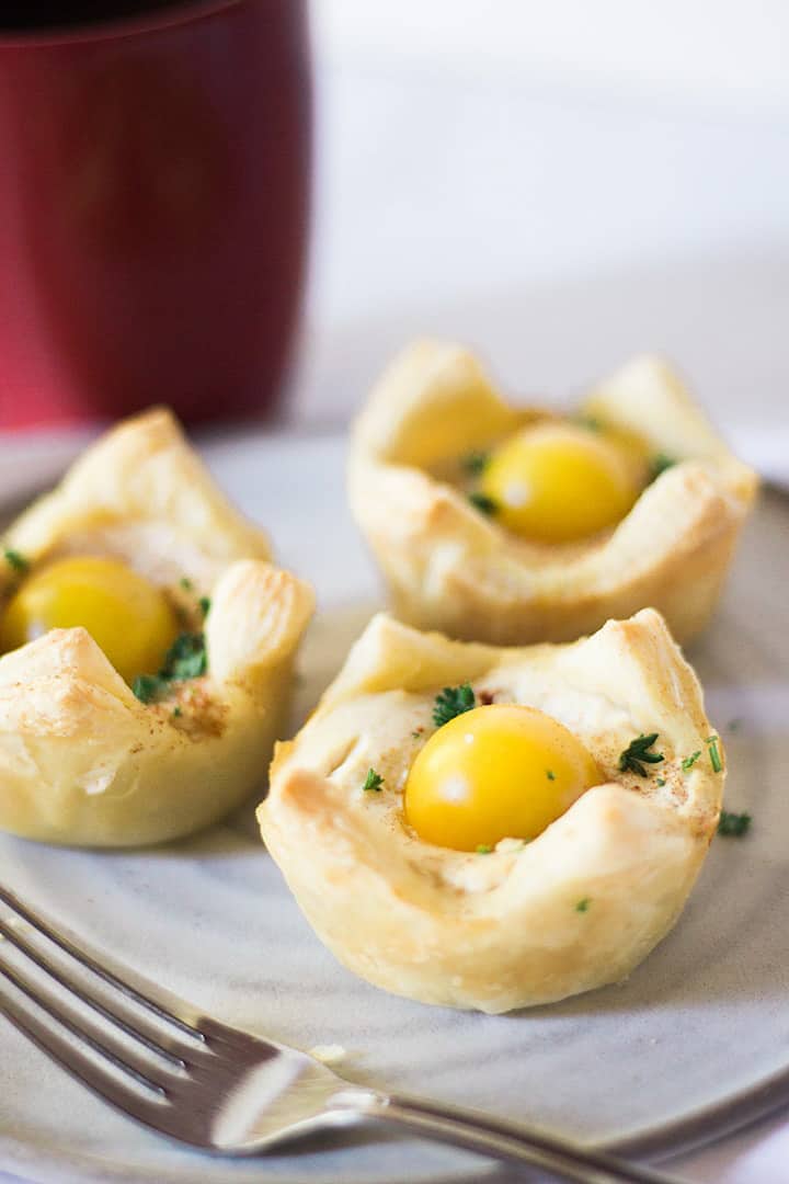 three vegan easter breakfast cups on a plate with a fork on the side 