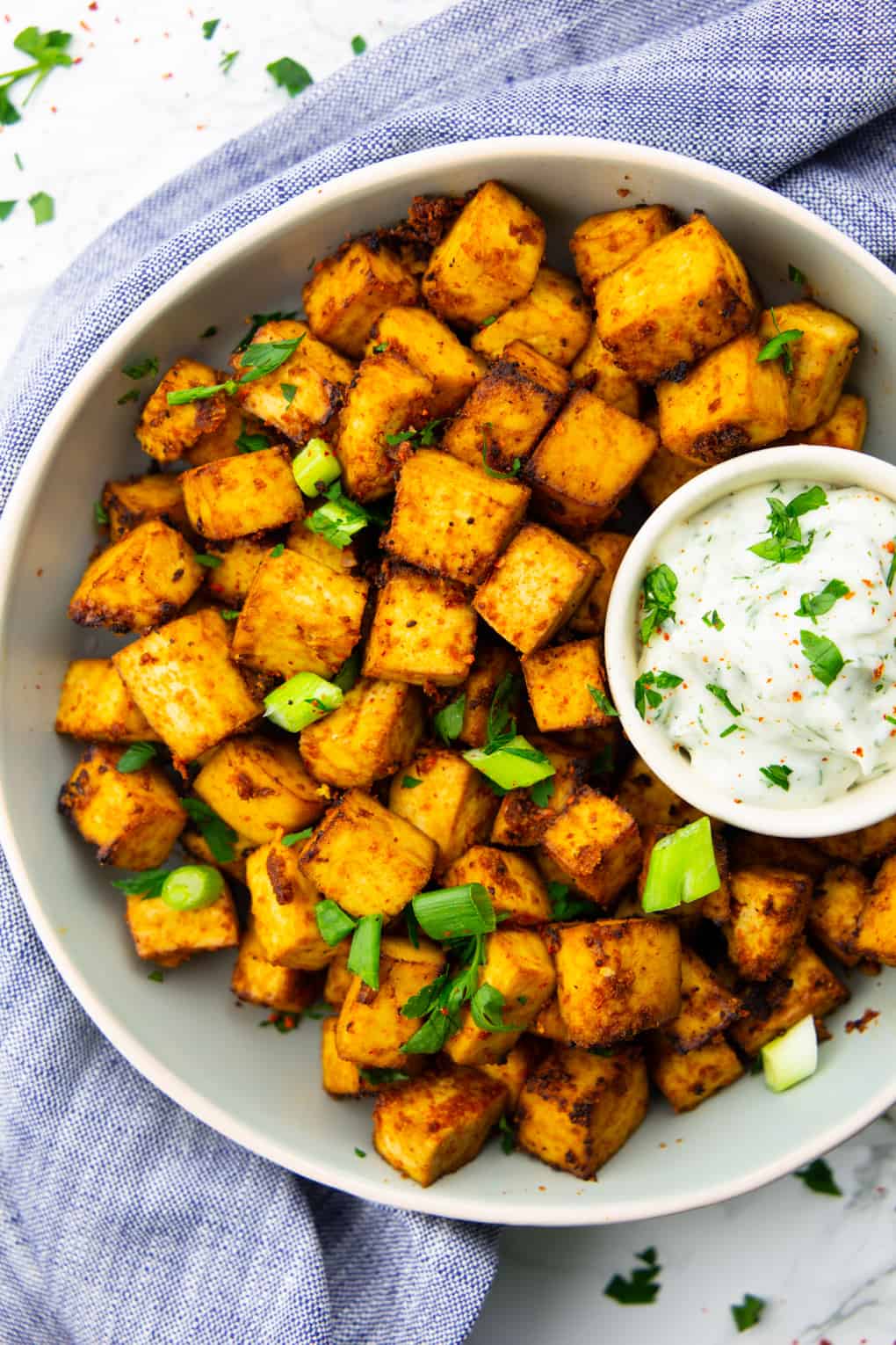 air fryer tofu cubes in a grey bowl with a small bowl of vegan mayonnaise 