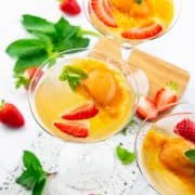 three glasses of champagne with sorbet and strawberries