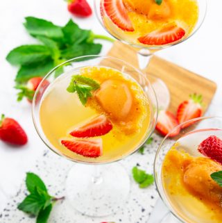 three glasses of champagne with sorbet and strawberries