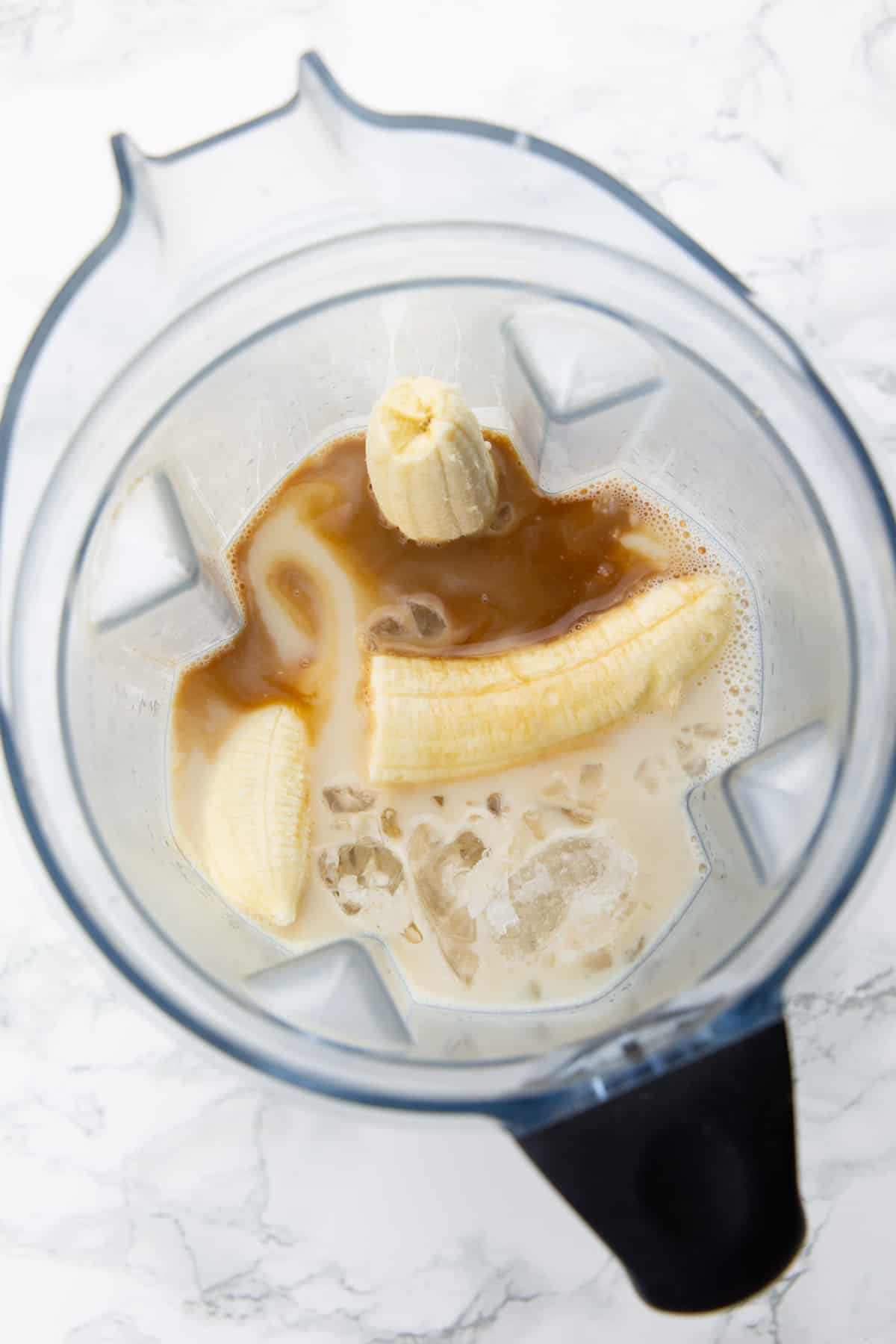 bananas, almond milk, crushed ice, and vanilla extract in a blender 
