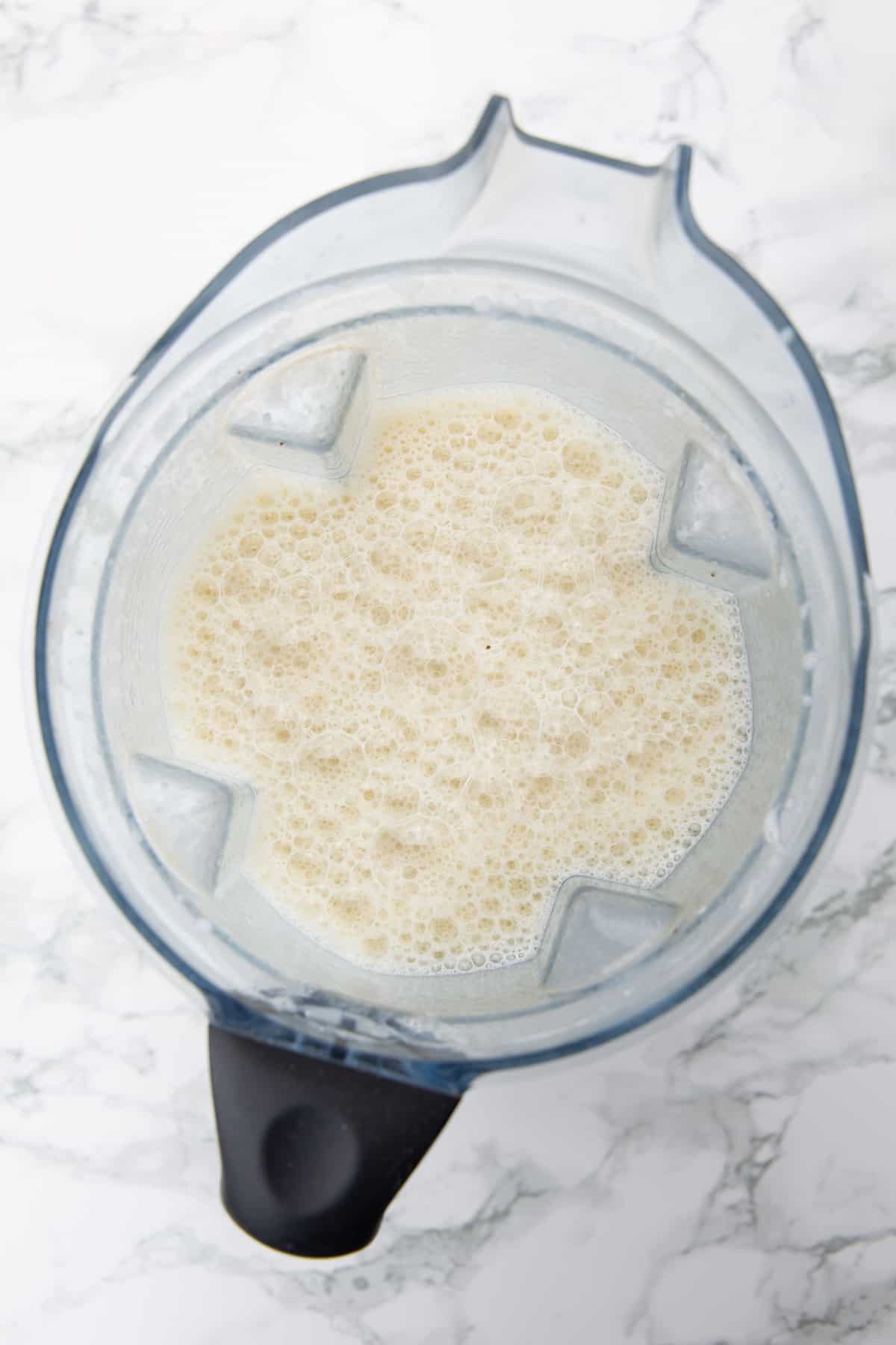 Banana Milk in a blender on a marble countertop 