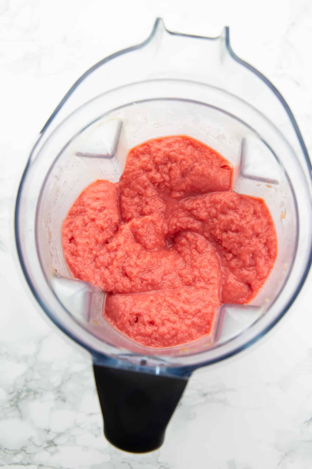Watermelon Smoothie in a blender on a marble countertop 