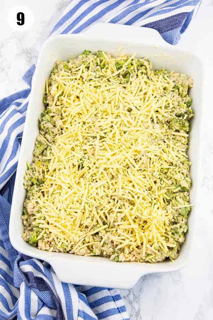 a baking dish with vegan broccoli rice casserole on a marble countertop 