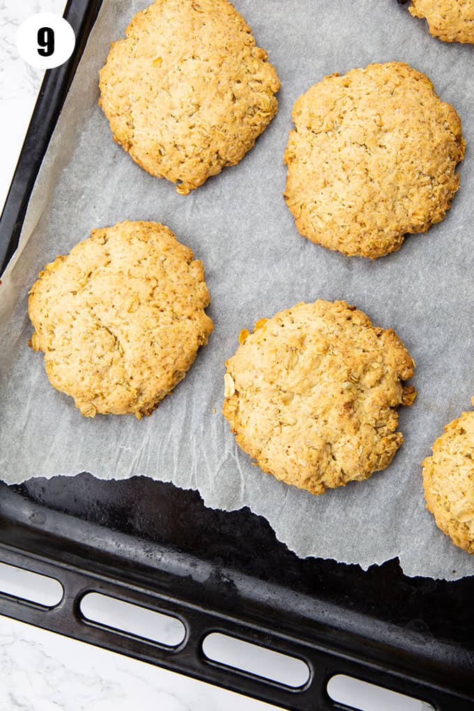 vegan oatmeal cookies on a baking tray lined with parchment paper 