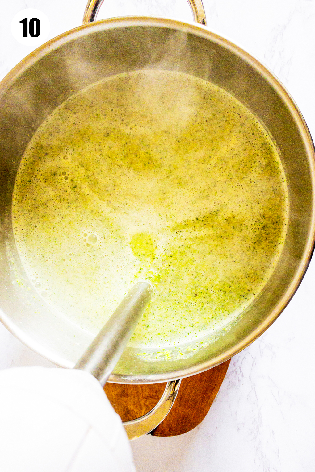 broccoli soup in a pot with an immersion blender 