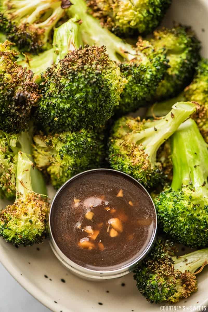 air fryer broccoli on a plate with a dip on the side 