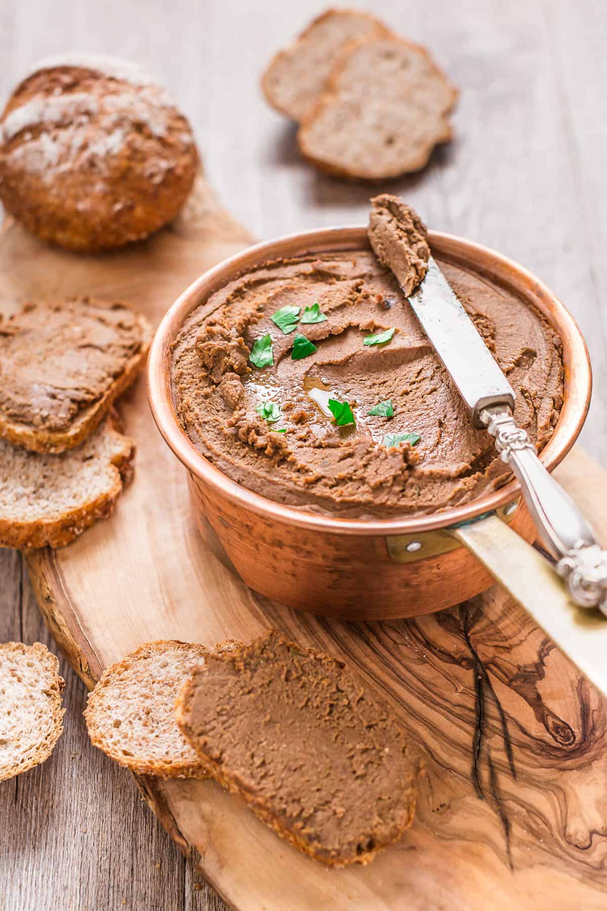 a pot with mushroom walnut lentil pate with slices of bread on the side