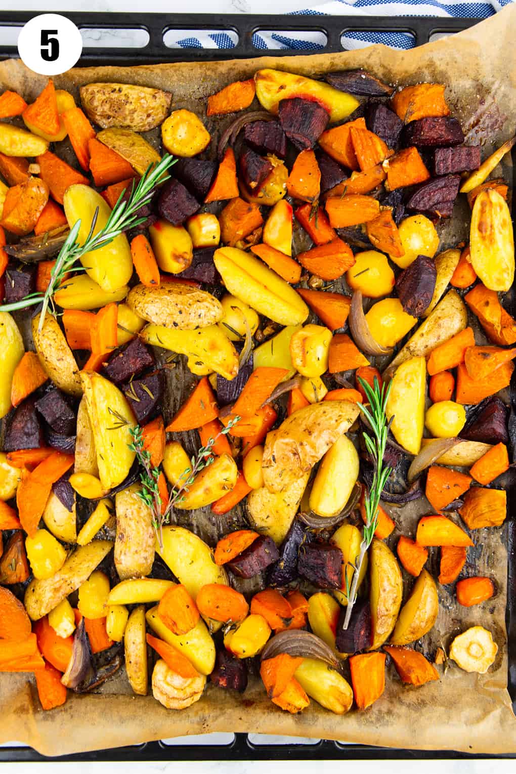 roasted root vegetables on a baking sheet lined with parchment paper