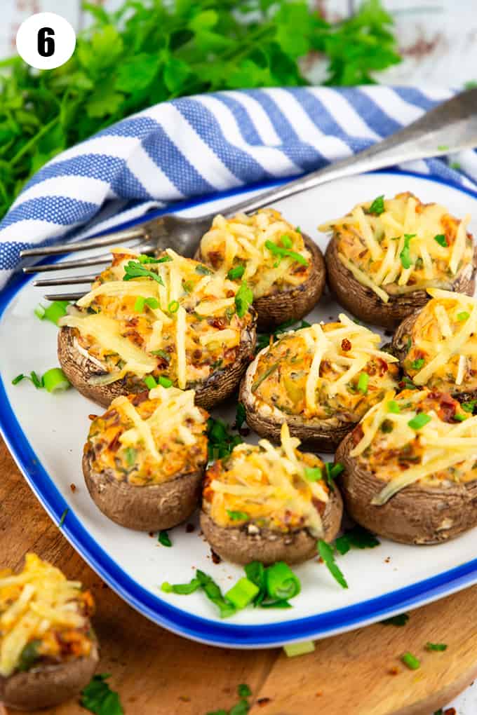 vegan stuffed mushrooms on a white plate with a fork on the side 