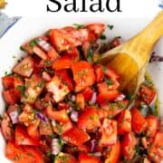 tomato onion salad in a white bowl with a text overlay