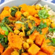 a grey bowl with pumpkin curry over rice with a text overlay
