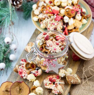 Christmas crunch in a glass jar on a wooden board