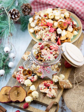 Christmas crunch in a glass jar on a wooden board