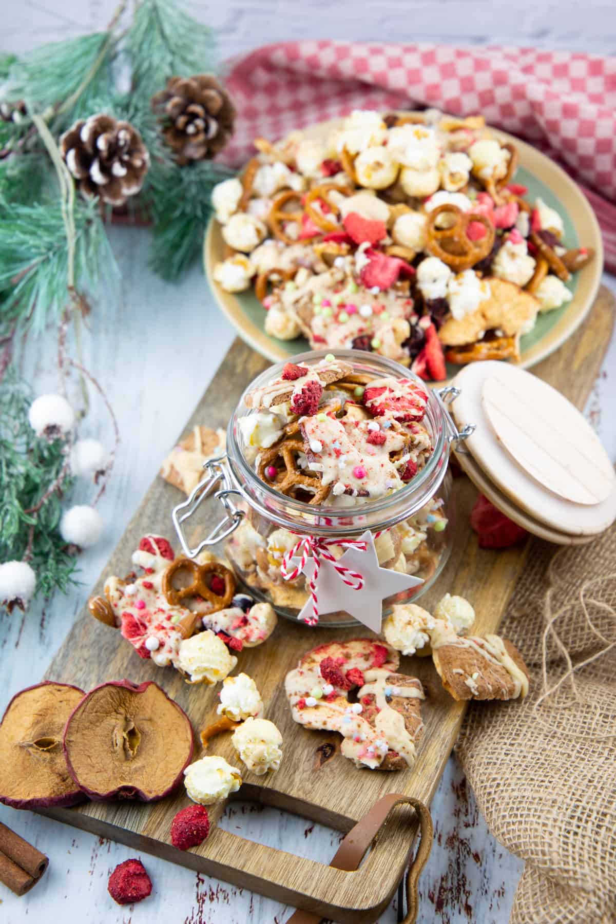 Christmas crunch in a glass jar on a wooden board 