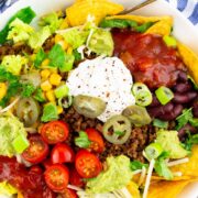 vegan taco salad in a white bowl with a text overlay