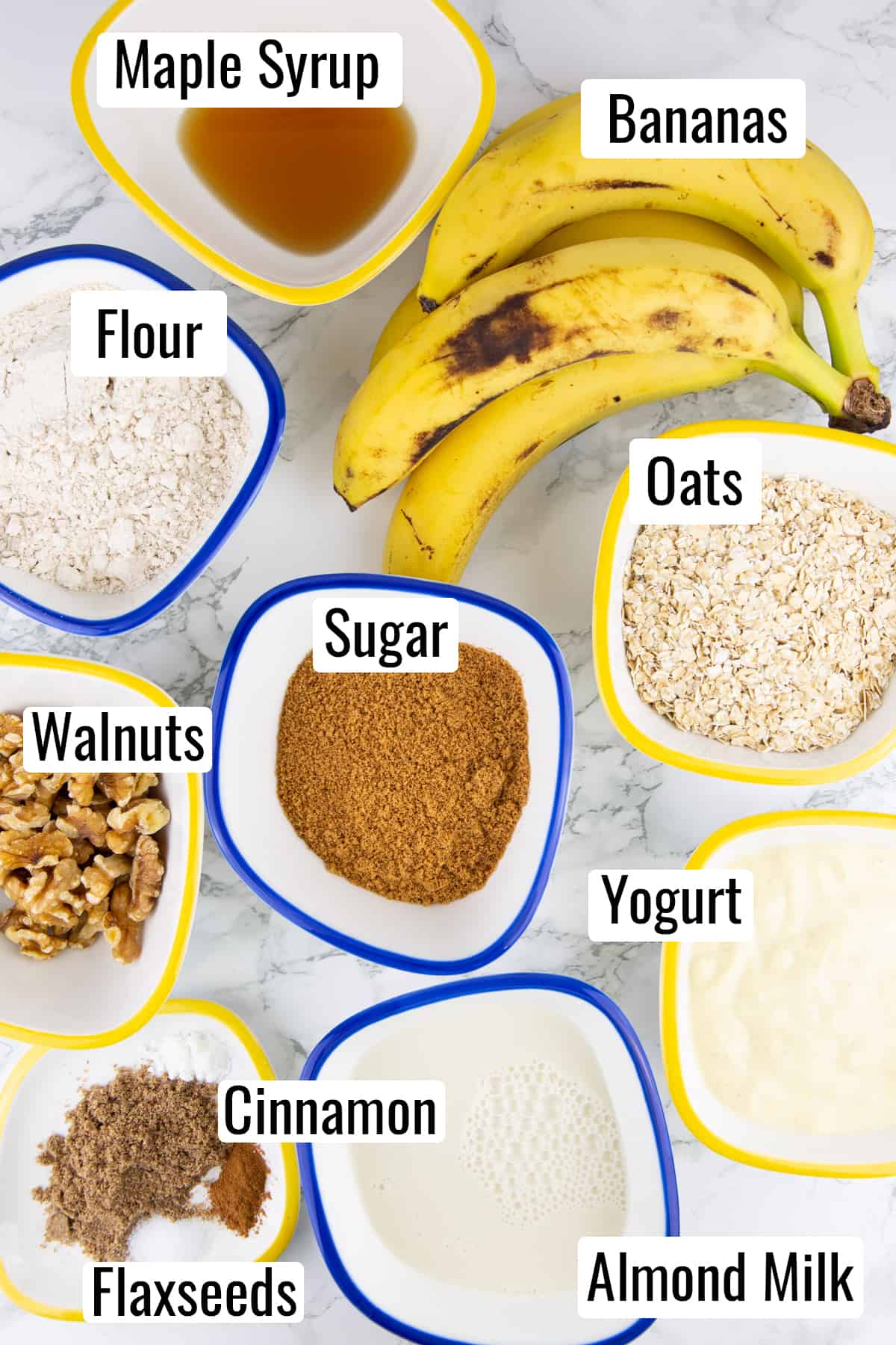 the ingredients that go into this recipe on a marble countertop with labels with the names of the ingredients