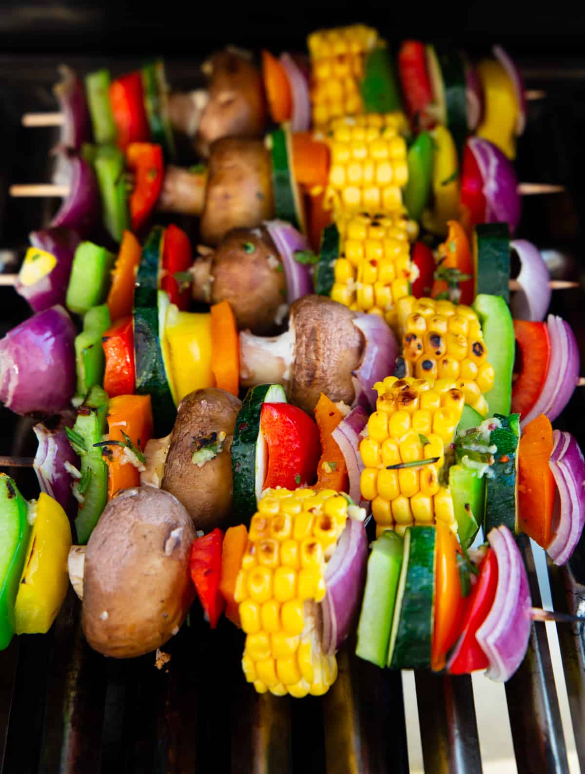 vegetable kabobs with bell pepper and corn on a grill 