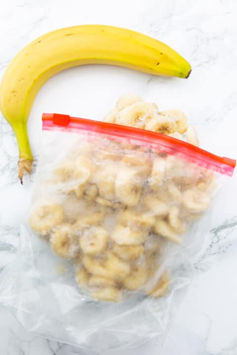 frozen banana slices in a ziplock bag on a marble countertop