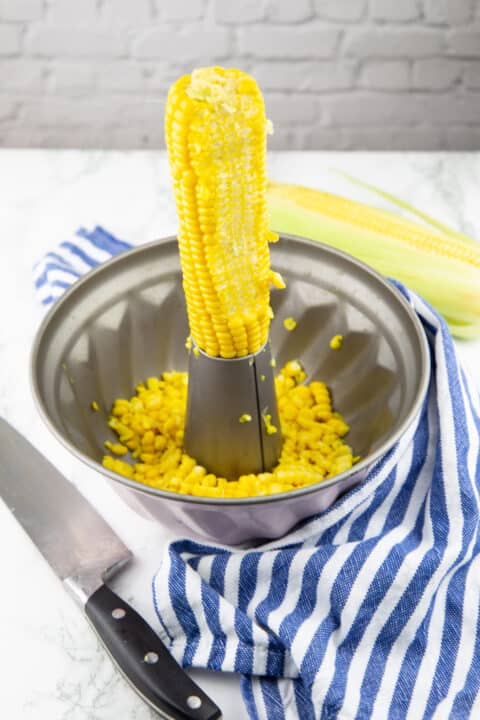 a corn cob on a bundt pan with a large knife on the side