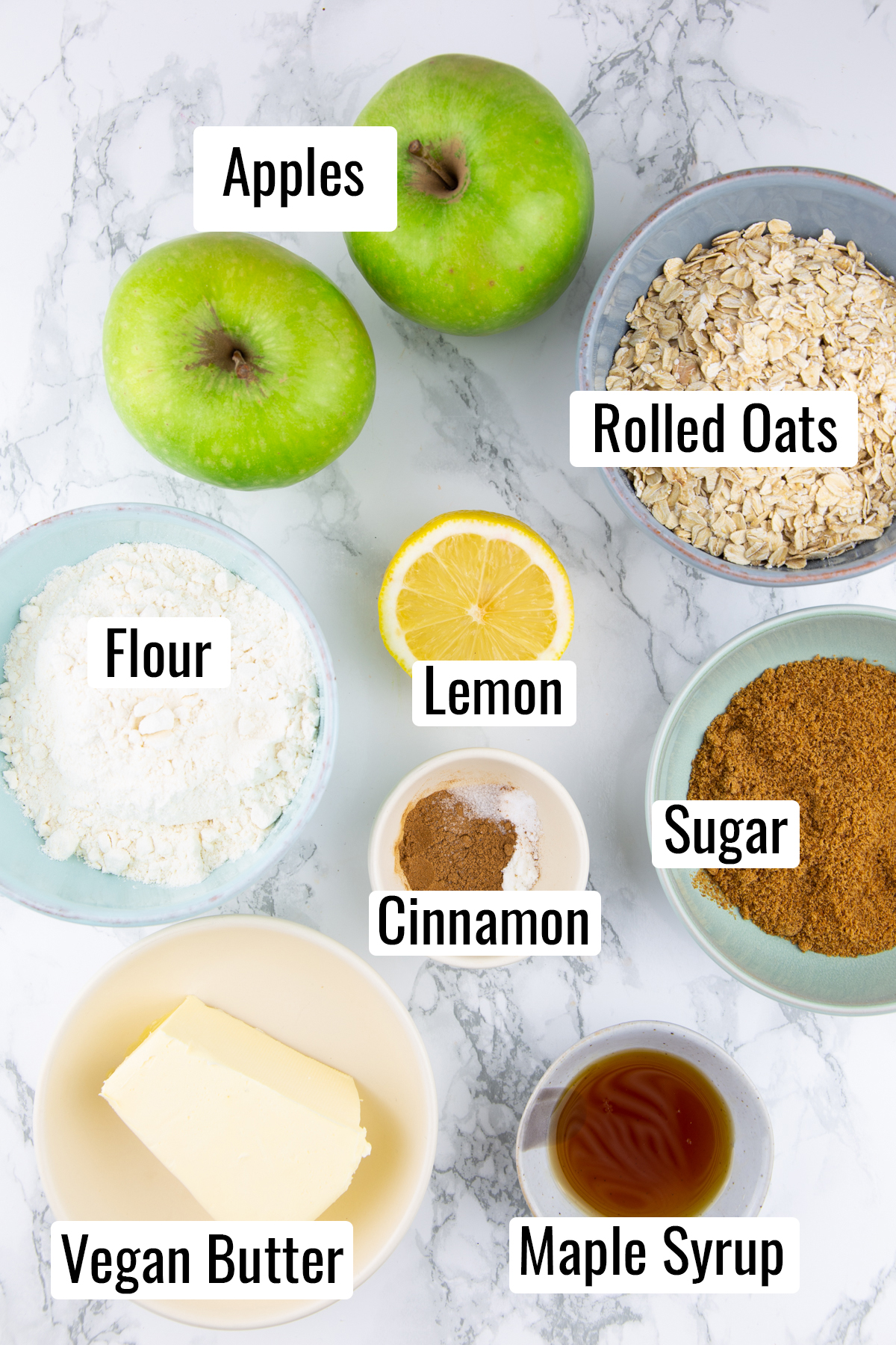 the ingredients that go into this recipe on a marble countertop with labels with the name of each ingredient 