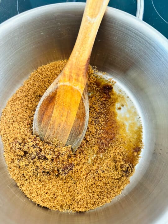 brown sugar in a pot with a wooden spoon 