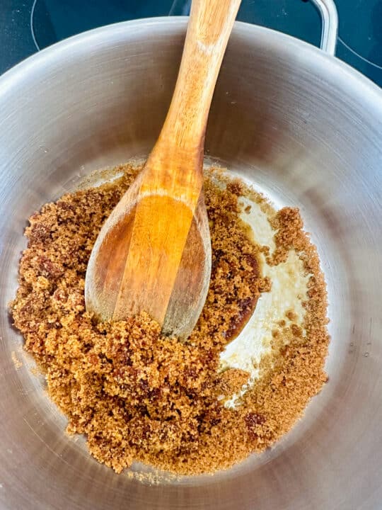 caramelized brown sugar in a pot with a wooden spoon 