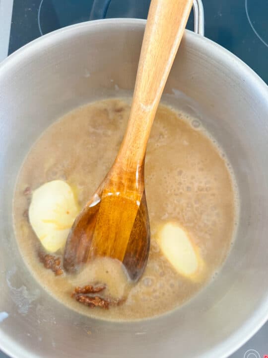 carmalized brown sugar with vegan butter in a pot with a wooden spoon 