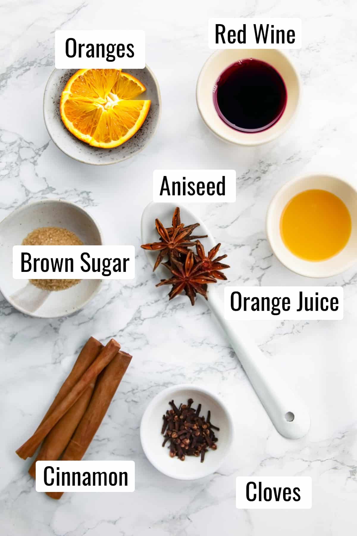 the ingredients that go into this recipe on a marble countertop with labels with the name of each ingredient