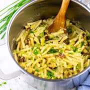 a pot with one pot pasta with leek and tofu on a marble countertop